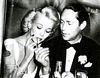 Franchot Tone lighting her fire, Screen Romances February 1941